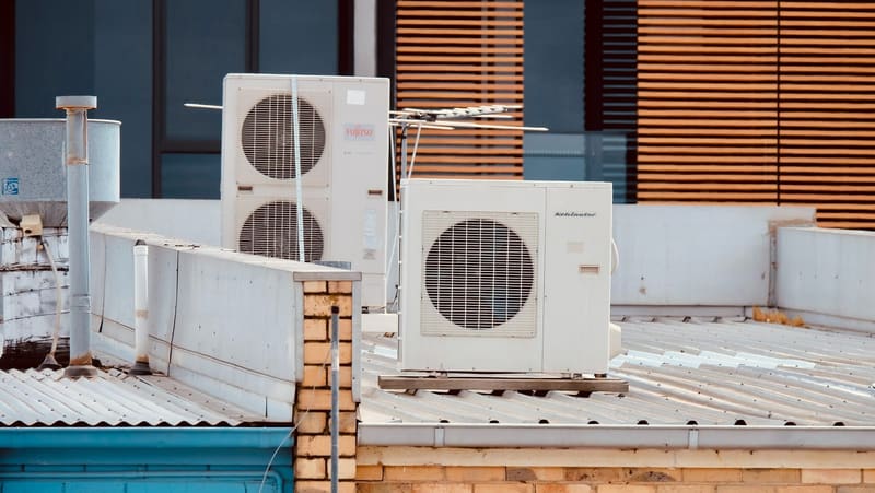 Commercial air conditioning condenser units installed on a rooftop in Kent